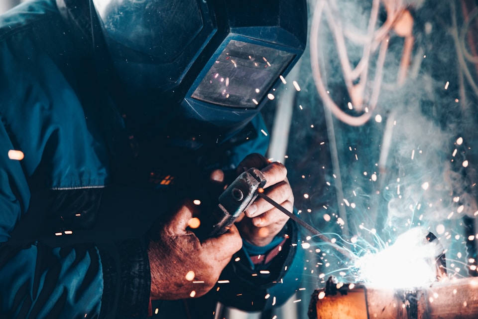Tradesperson welding metal in a workshop